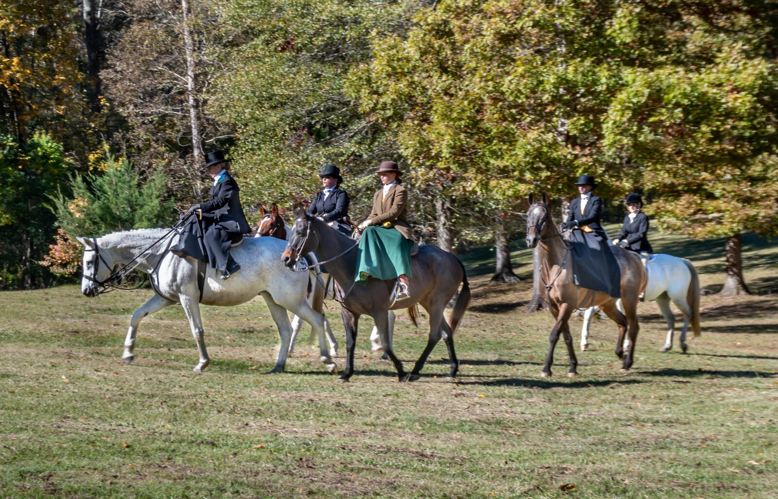 Members riding together through the fall fields